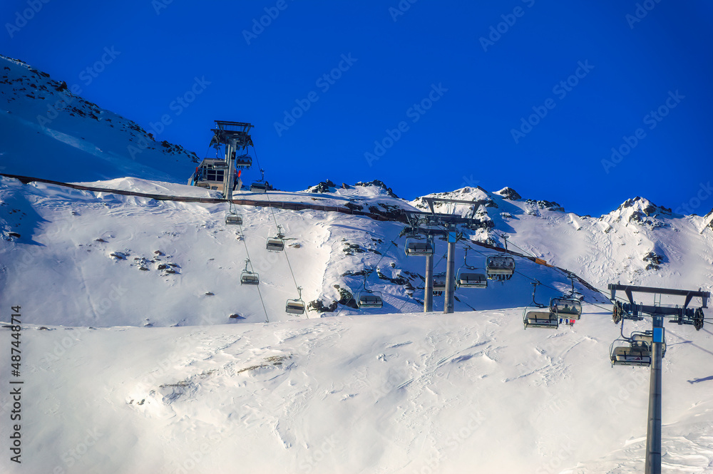 Fototapeta premium Ski lift at snow covered hills of Soelden, Austria.