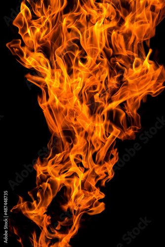 Bright orange yellow red Fire flame against black background, abstract texture 