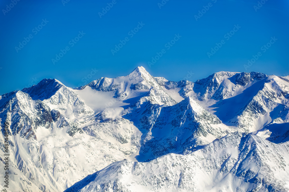 Obraz premium Austrian Alps covered with snow during sunny winter day.