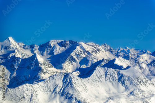 Austrian Alps covered with snow during sunny winter day.
