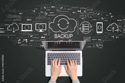 Backup concept with person using a laptop computer photo