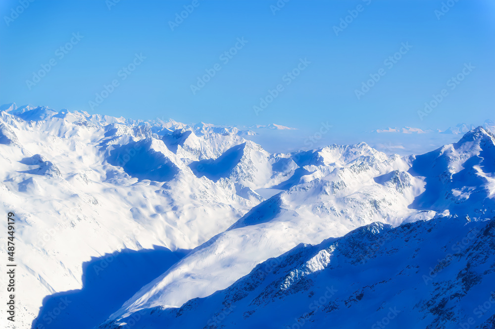Obraz premium Austrian Alps covered with snow during sunny winter day.