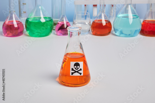 Canvas Print Orange toxin vial on a chemical desk