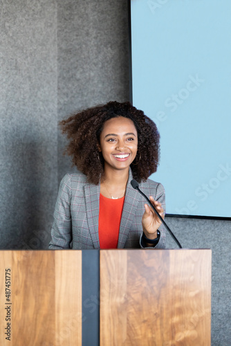 woman holding a a microphone while speaking