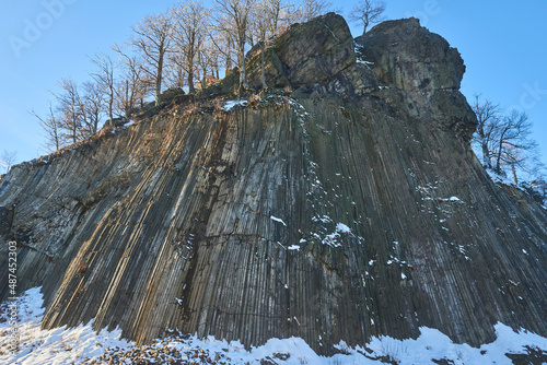 Winter in the Lusatian mountains in the north of the Czech Republic. Basalt rock Zlaty vrch. Volcano rock formation Zlaty vrch built pentagonal and hexagonal basalt columns. 