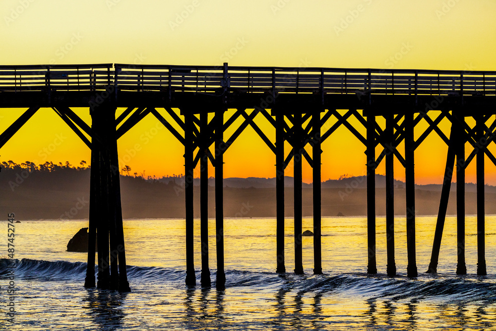 Pier Pylons and Ocean and Beach at sunrise, sunset