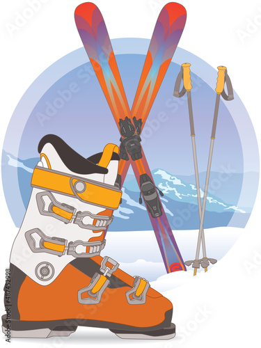 freestyle skiing, ski boot, pair of skis crossed and ski poles in snow with mountains in background
