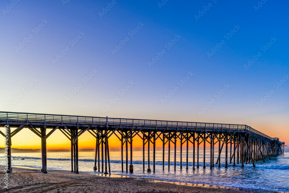 Pier, ocean, sand, beach at sunrise, sunset