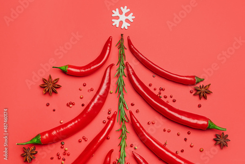Fototapeta Naklejka Na Ścianę i Meble -  Christmas tree made of hot chili peppers and spices on red background