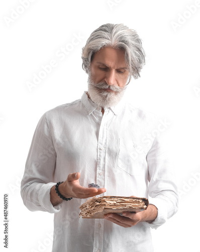 Mature man with old book an...