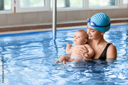 Swimming coach and cute lit...