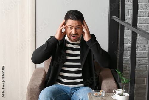 Stressed man with coffee an...