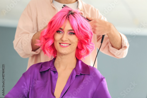 Male stylist doing hair of ...