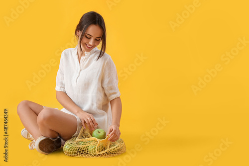 Young woman with string bag...