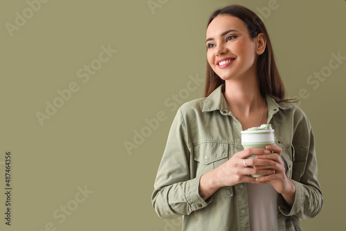 Young woman with paper cup ...