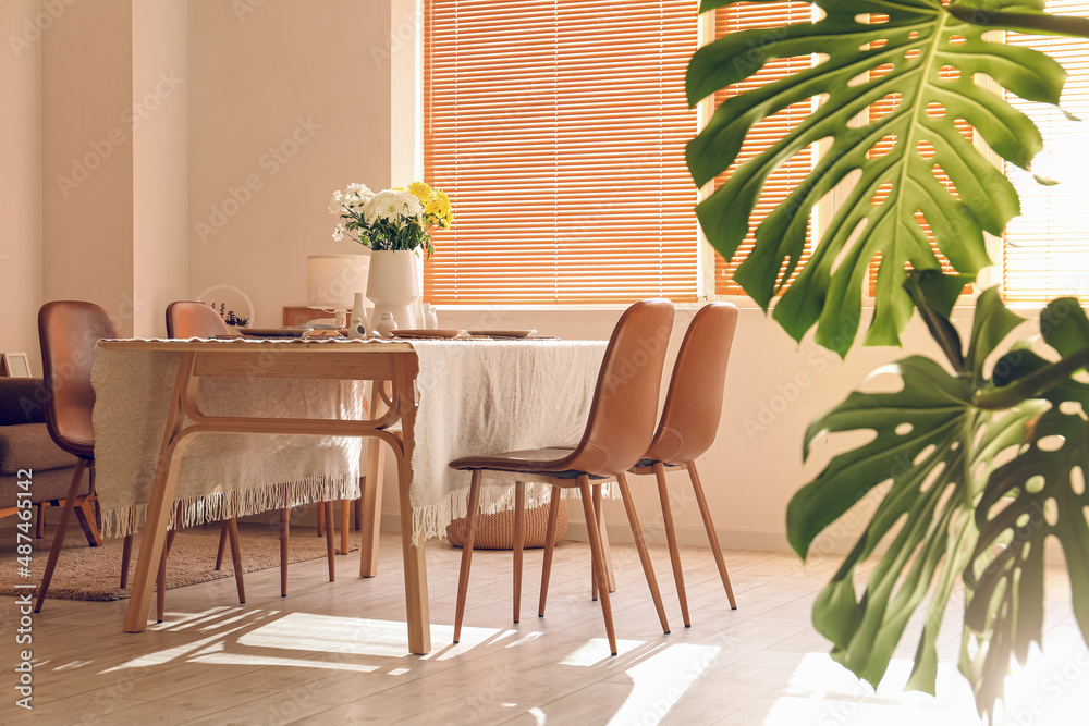 Fototapeta premium Interior of dining room with table served for International Women's Day celebration