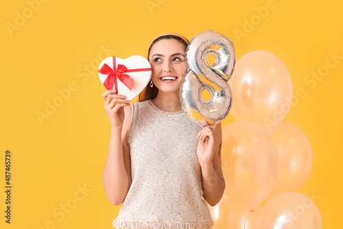 Happy young woman holding h...