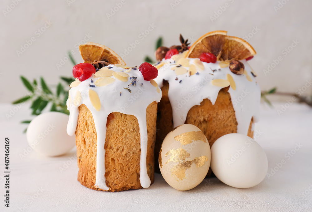 Delicious Easter cakes and eggs on light background Delicious Easter cakes and eggs on light background