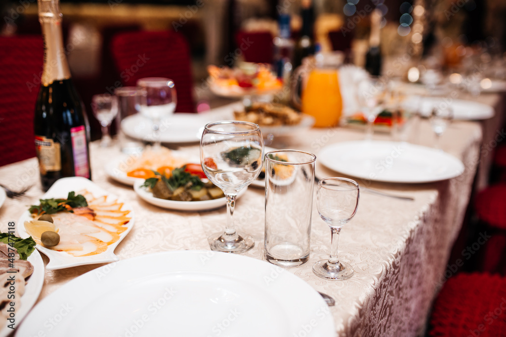 beautifully set table at a wedding banquet with delicious food and alcohol