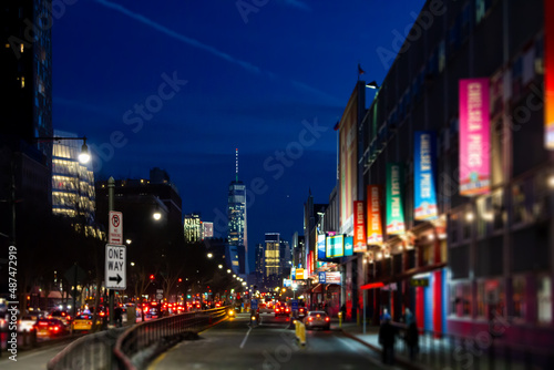 New York City night street scene at Chelsea Pier with blurred lights of the buildings and cars