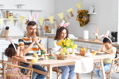 Happy family praying at din...
