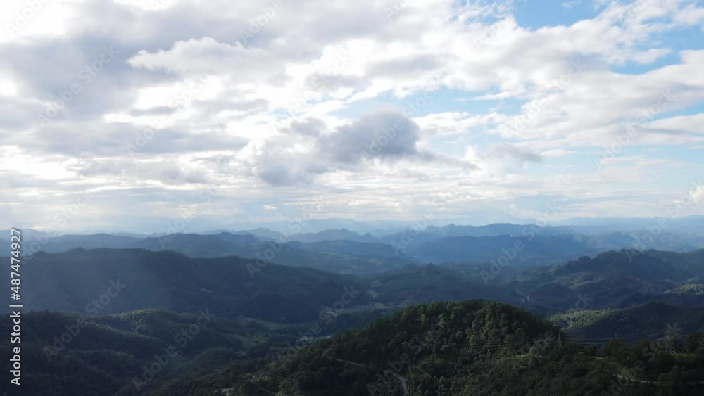 Top view mountains are covered with many green plants. Under the sky and sunlight shining through the clouds. Top view mountains are covered with many green plants. Under the sky and sunlight shining through the clouds.