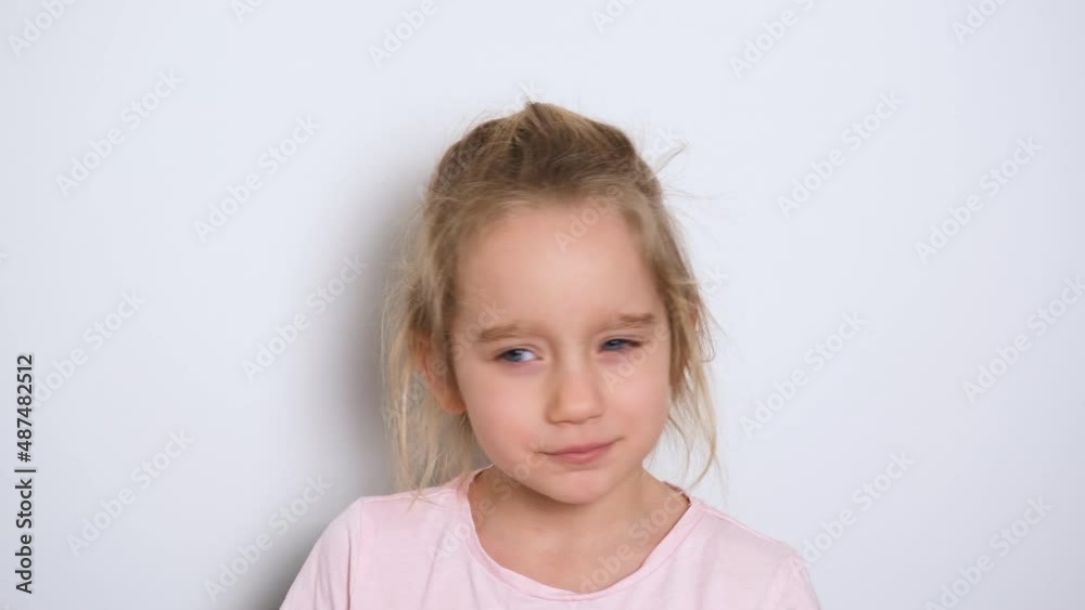 A little girl is actively telling something and looking at the camera. The girl sings or recites a poem. Video portrait. 4k resolution video. A little girl is actively telling something and looking at the camera. The girl sings or recites a poem. Video portrait. 4k resolution video.