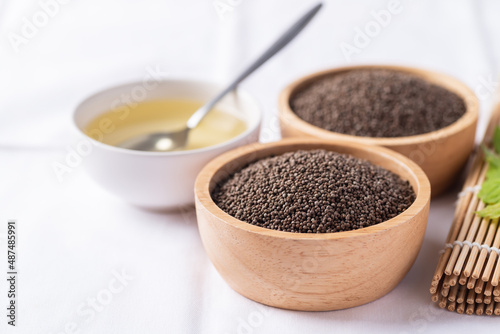 Perilla oil and seeds in bowl on white background  Healthy herbal seed ingredients in Asian food