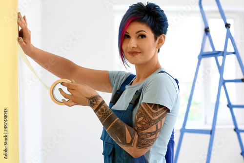 Female decorator with tape ...