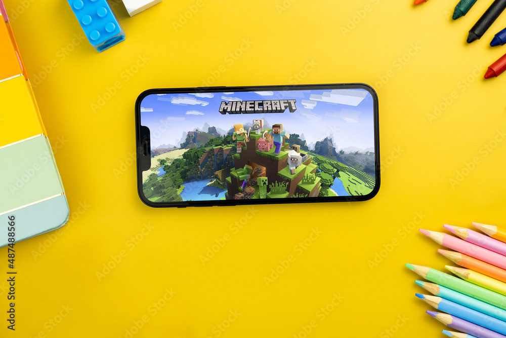 Minecraft mobile game app on the smartphone screen. Yellow background ...