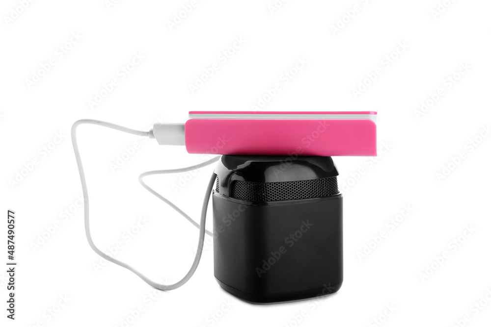 Pink power bank with speaker on white background Pink power bank with speaker on white background