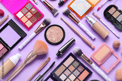 Obraz na plátně Beautiful makeup brushes with decorative cosmetics on lilac background
