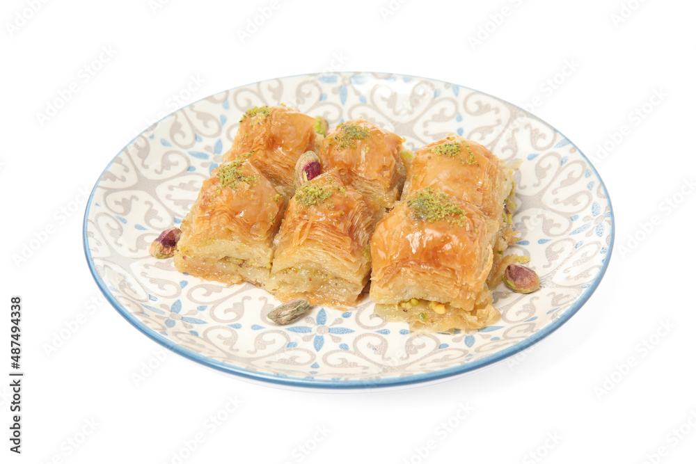 Plate of delicious baklava with pistachio nuts isolated on white