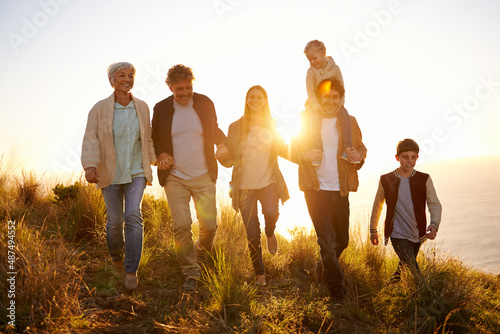 Touched by gold. Shot of a happy family out on a morning walk together.