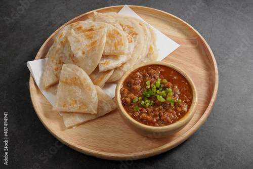 Roti with pork sauce in a wooden cup Indian style food