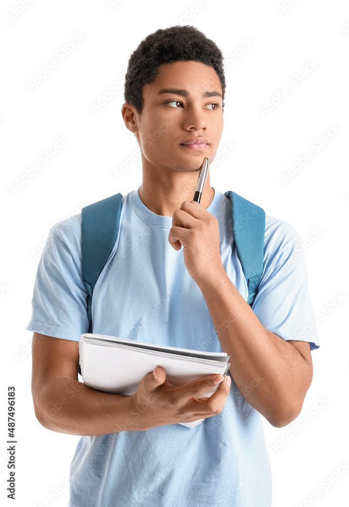Pensive male AfricanAmerican student with notebook and pen on white