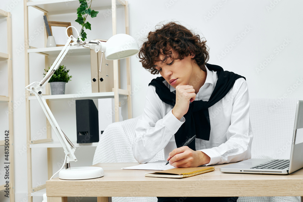curly guy laptop sitting on white sofa online training living room