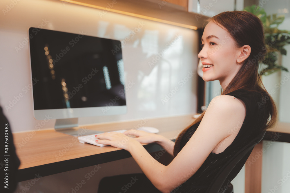 Young beautiful female smiling working with computer desktop at modern office Young beautiful female smiling working with computer desktop at modern office