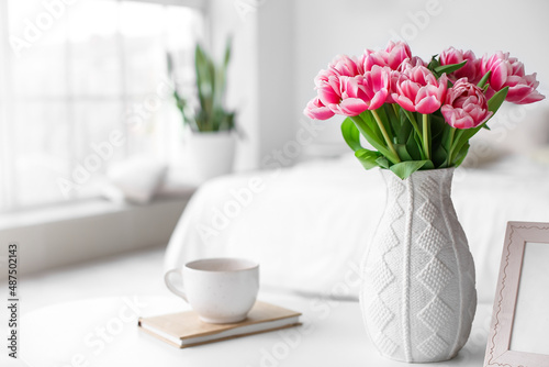 Vase with tulips, book and ...