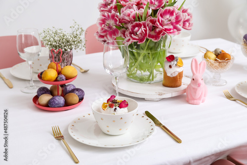 Plate with Easter cake on festive served table