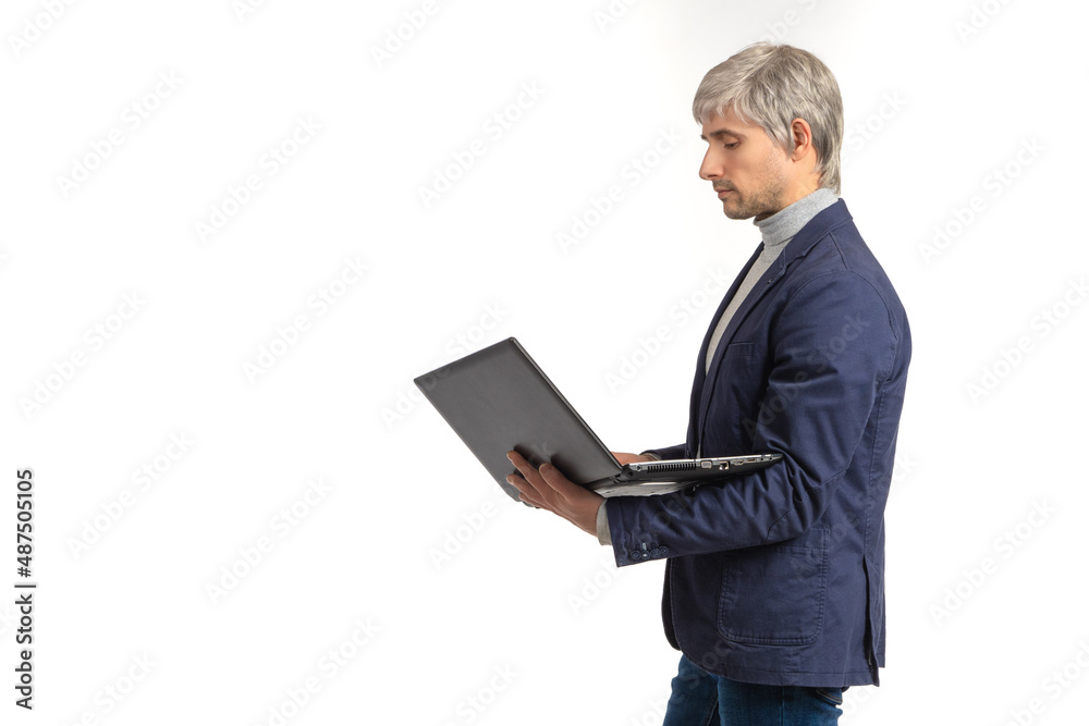 Experienced businessman. Man with laptop. Experienced businessman on white. Gray-haired man is holding computer. Businessman in jacket. Concept software for business. Place for your inscription Experienced businessman. Man with laptop. Experienced businessman on white. Gray-haired man is holding computer. Businessman in jacket. Concept software for business. Place for your inscription