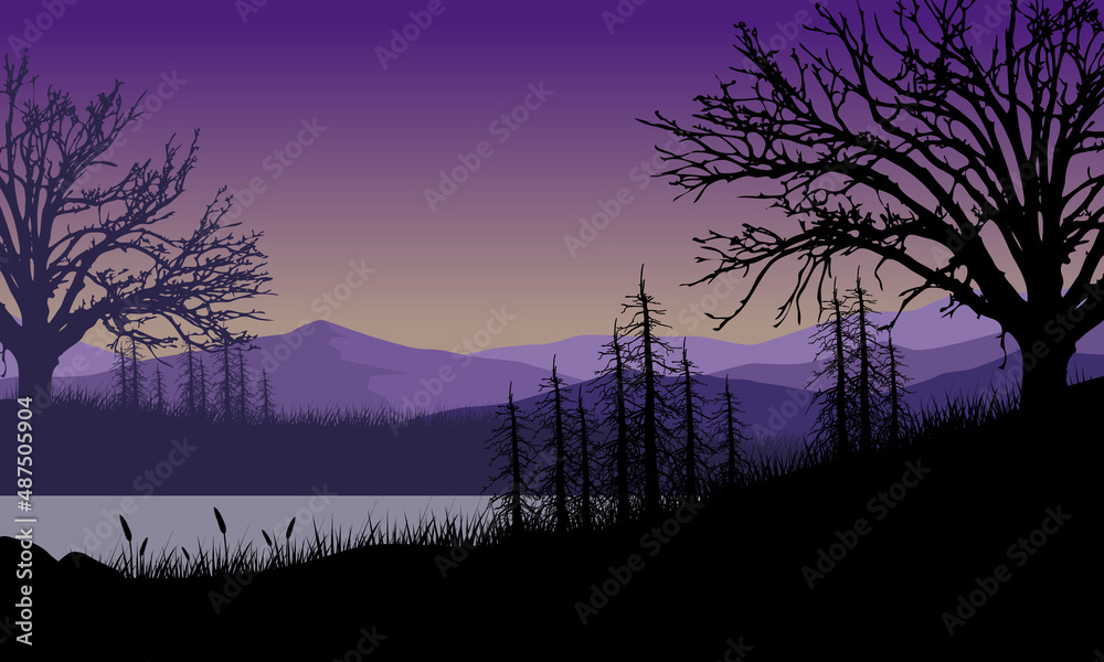 Fototapeta premium The beautiful mountain view by the river with grass silhouettes around it