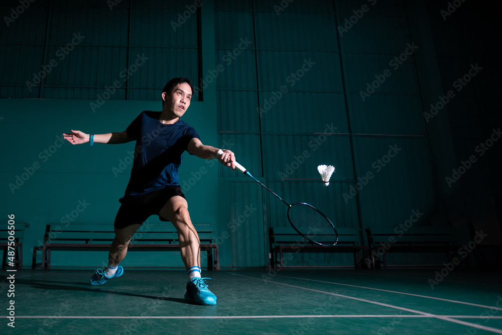 professional badminton player use racquet hit shuttle cock or shuttlecock on court during warm up play before tournament competition in single man type in indoor court