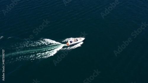 Wallpaper Mural Flying over a white speed boat in motion. White big boat fast movement on dark blue water aerial view. High-speed motor boat with people moving on the water. Torontodigital.ca