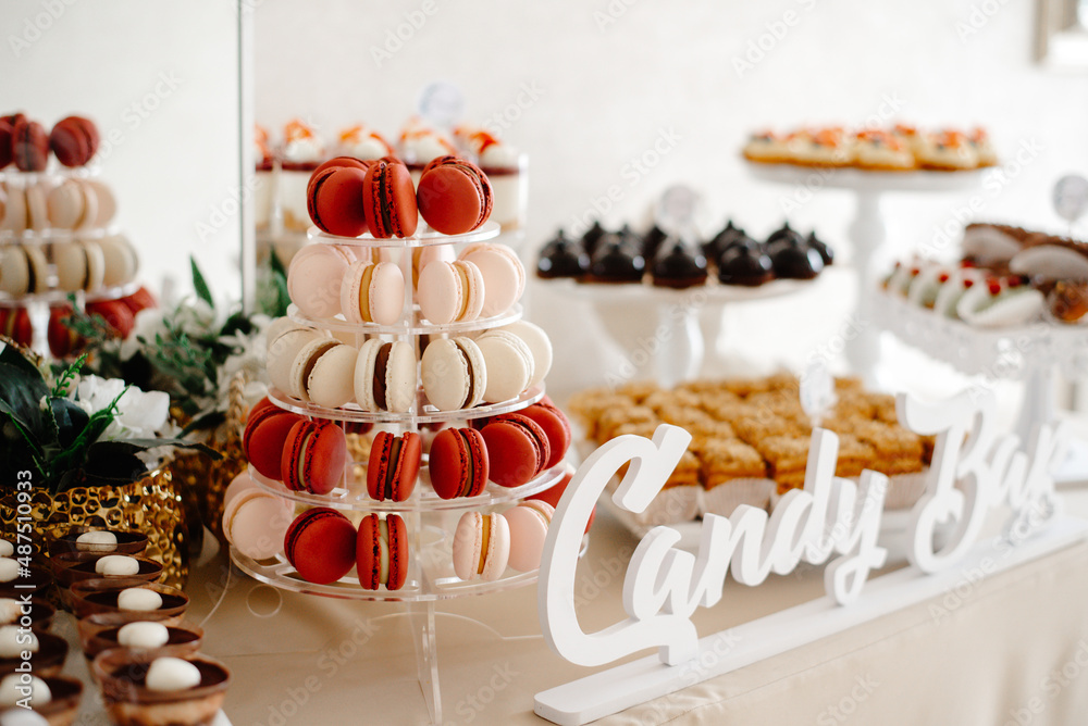 cake with candles, candy bar for wedding, macarons with candles.