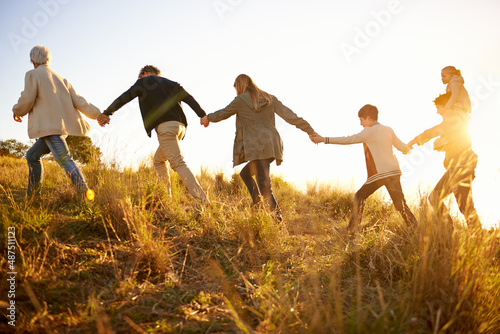 Safe in each others hands. Shot of a happy family holding hands on a morning walk together.