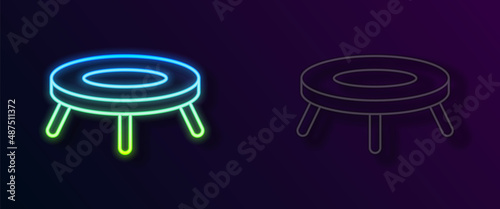 Glowing neon line Jumping trampoline icon isolated on black background. Vector