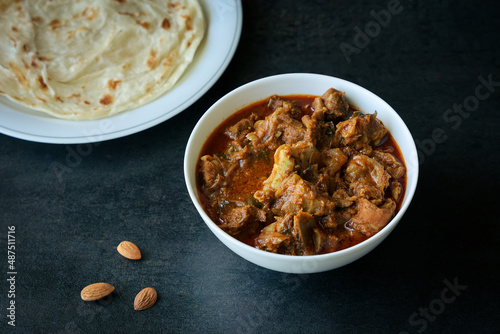 Meat beef curry Kerala paratha porotta roti mutton curry roast with Indian layered flatbread for breakfast snack, popular street food India ramadan festival . Maida wheat flour Cooking.