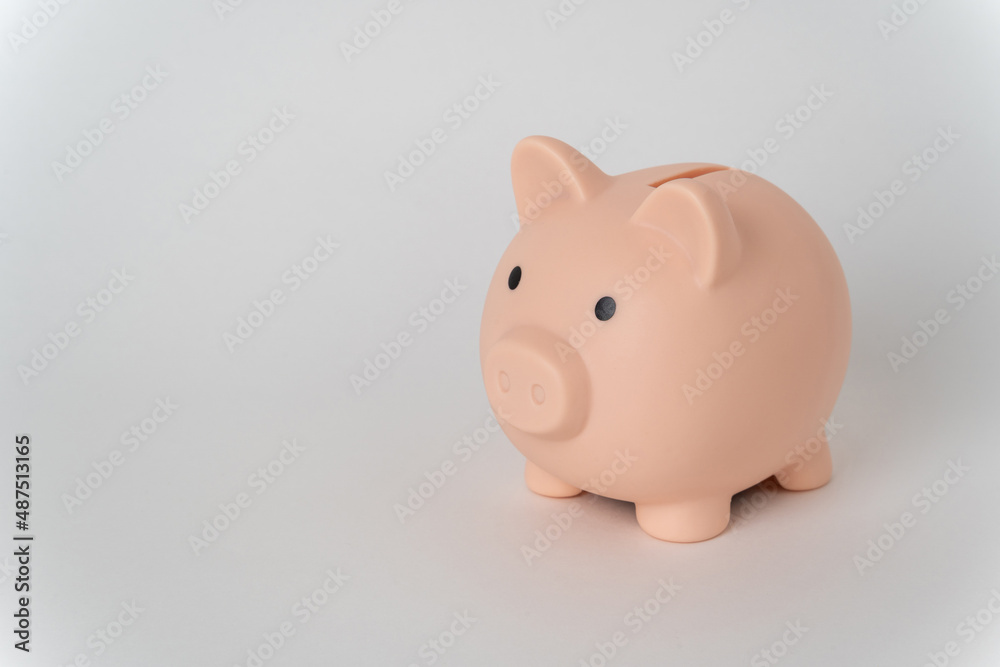 Pink piggy bank on a white background. The concept of money accumulation, financial well-being, banking security, pension savings.