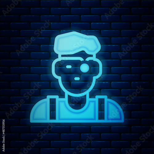 Glowing neon Jeweler man icon isolated on brick wall background. Vector